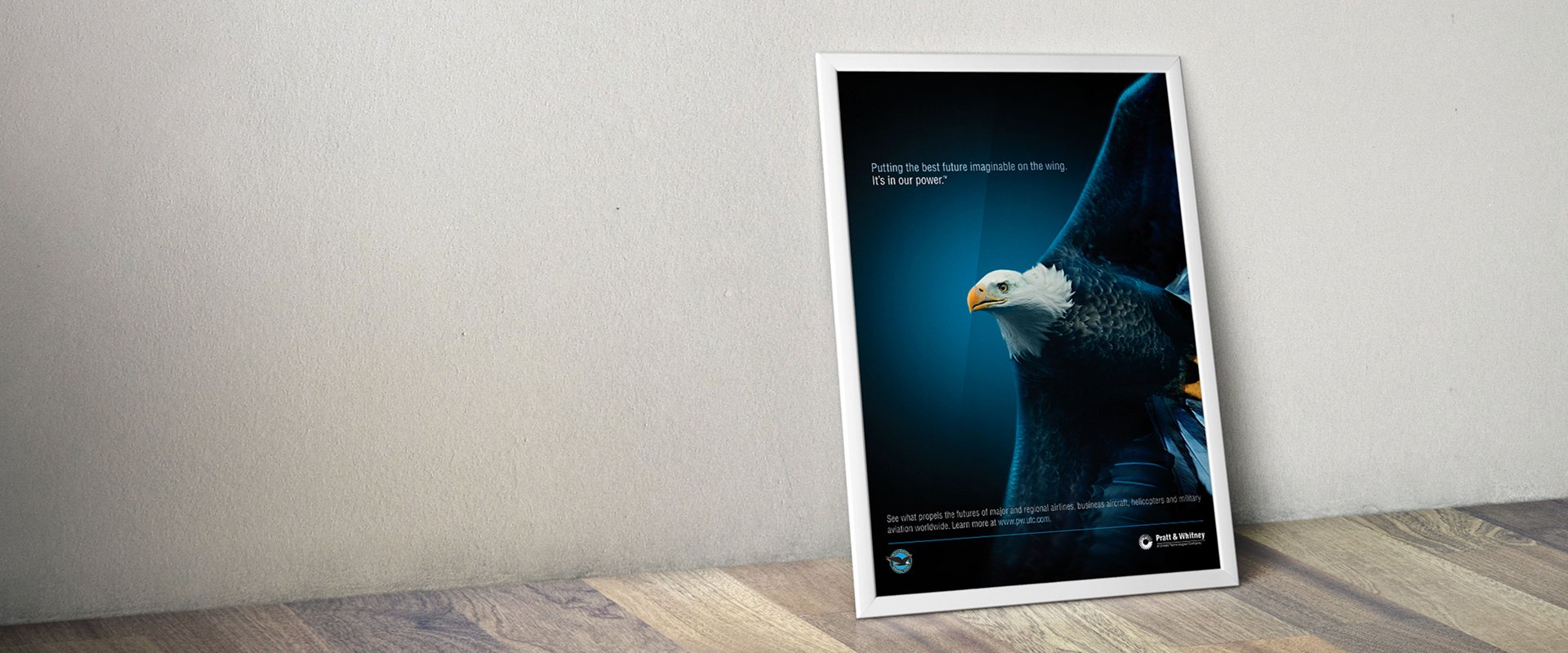 Advertising print in frame showing an eagle flying with a clever tagline for an aviation company.